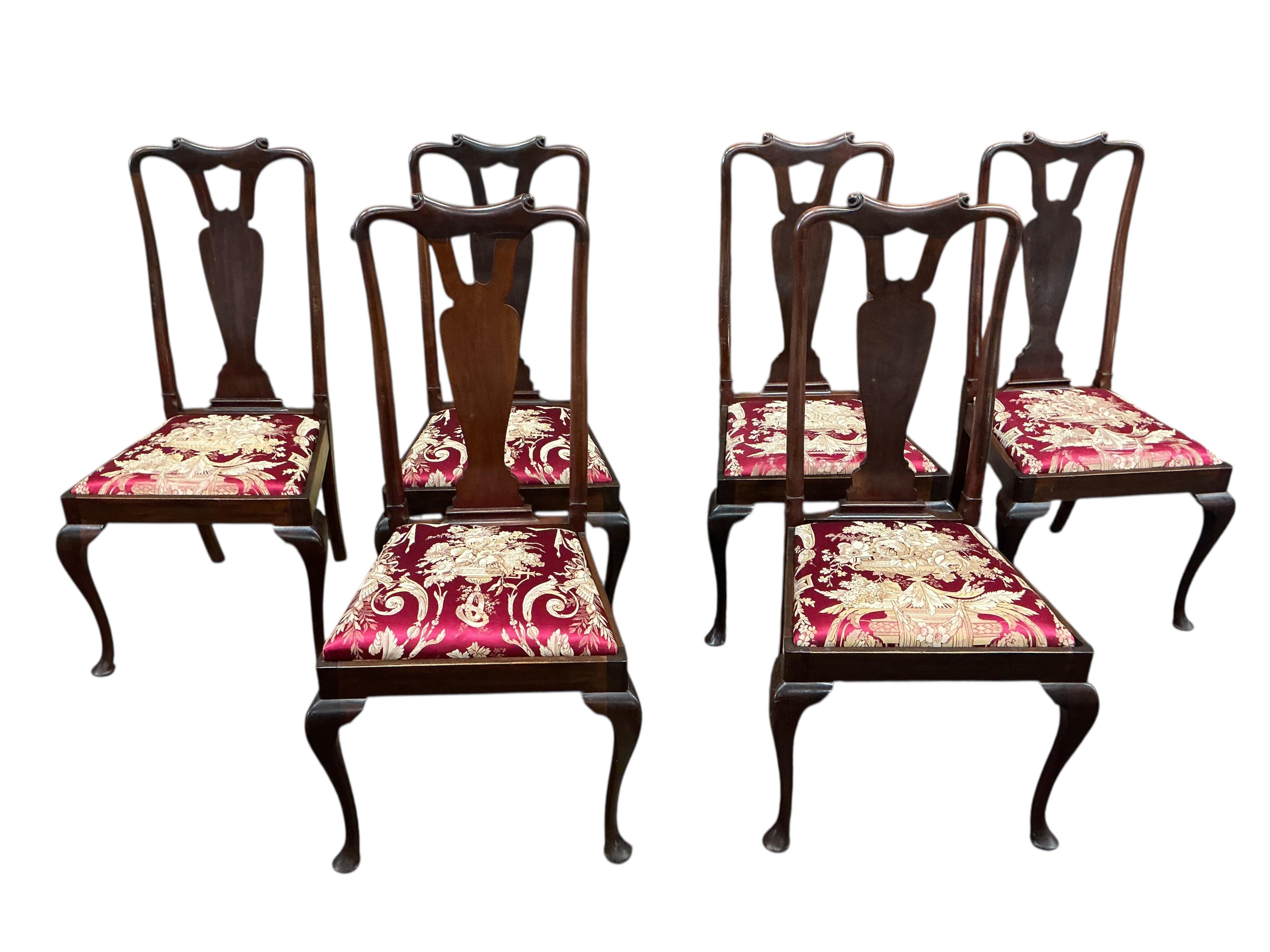 A set of eight early 20th century Queen Anne style mahogany dining chairs with silk brocade drop in seats, two with arms